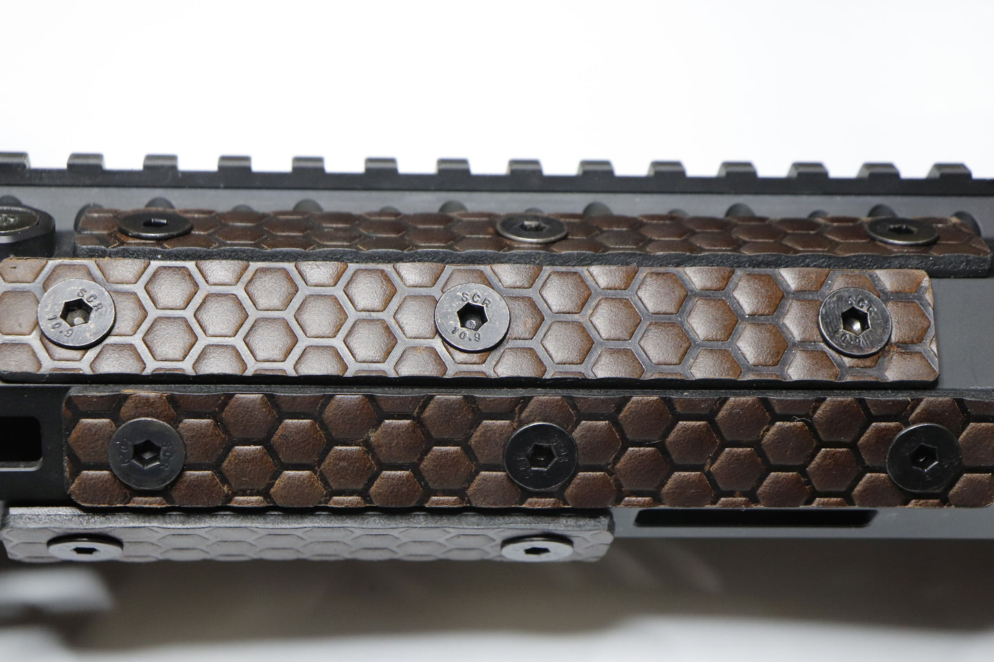 Handcrafted leather rail grip for MLOK rifle rails, featuring a textured surface with 1mm of g10 material on back for heat resistance, cool, new, best handguard.