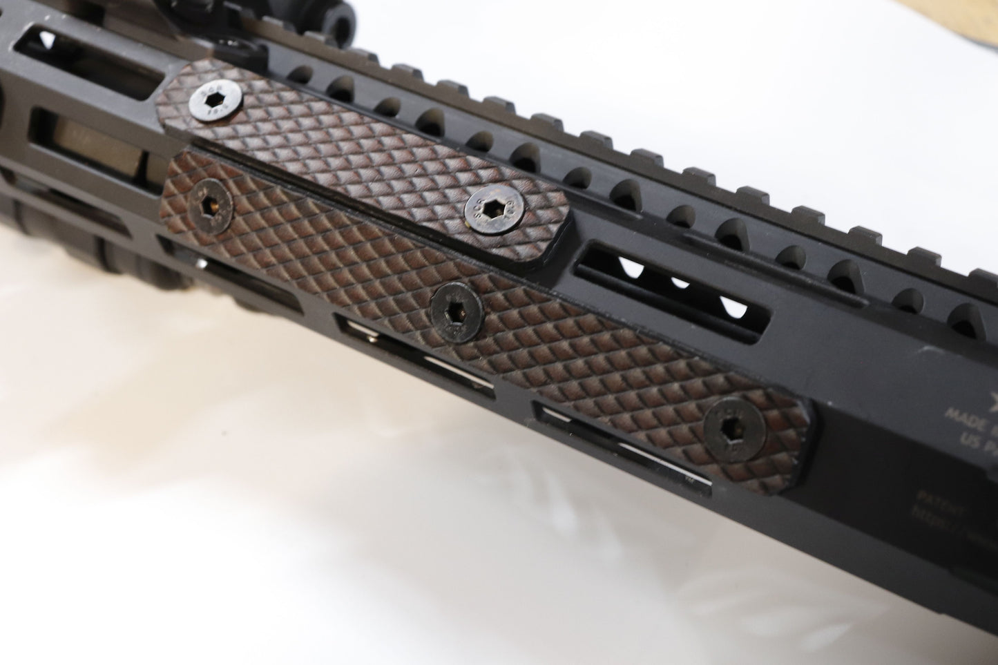 Handcrafted leather rail grip for MLOK rifle rails, featuring a textured surface with 1mm of g10 material on back for heat resistance, cool, new, best handguard.